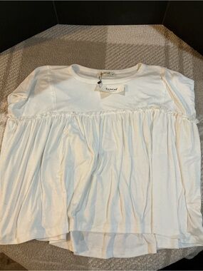 Woman’s White Ruffled Swing Top by Three bird nest